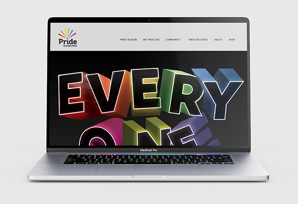 The image shows a MacBook Pro laptop displaying the Pride Winnipeg website. The website's homepage features the words EVERY ONE stacked vertically in large colorful three-dimensional lettering against a dark background. Above this graphic, the Pride Winnipeg logo is visible on the left, and a navigation menu with options like PRIDE SEASON GET INVOLVED COMMUNITY is on the right. The laptop is silver and shown against a light gray background.